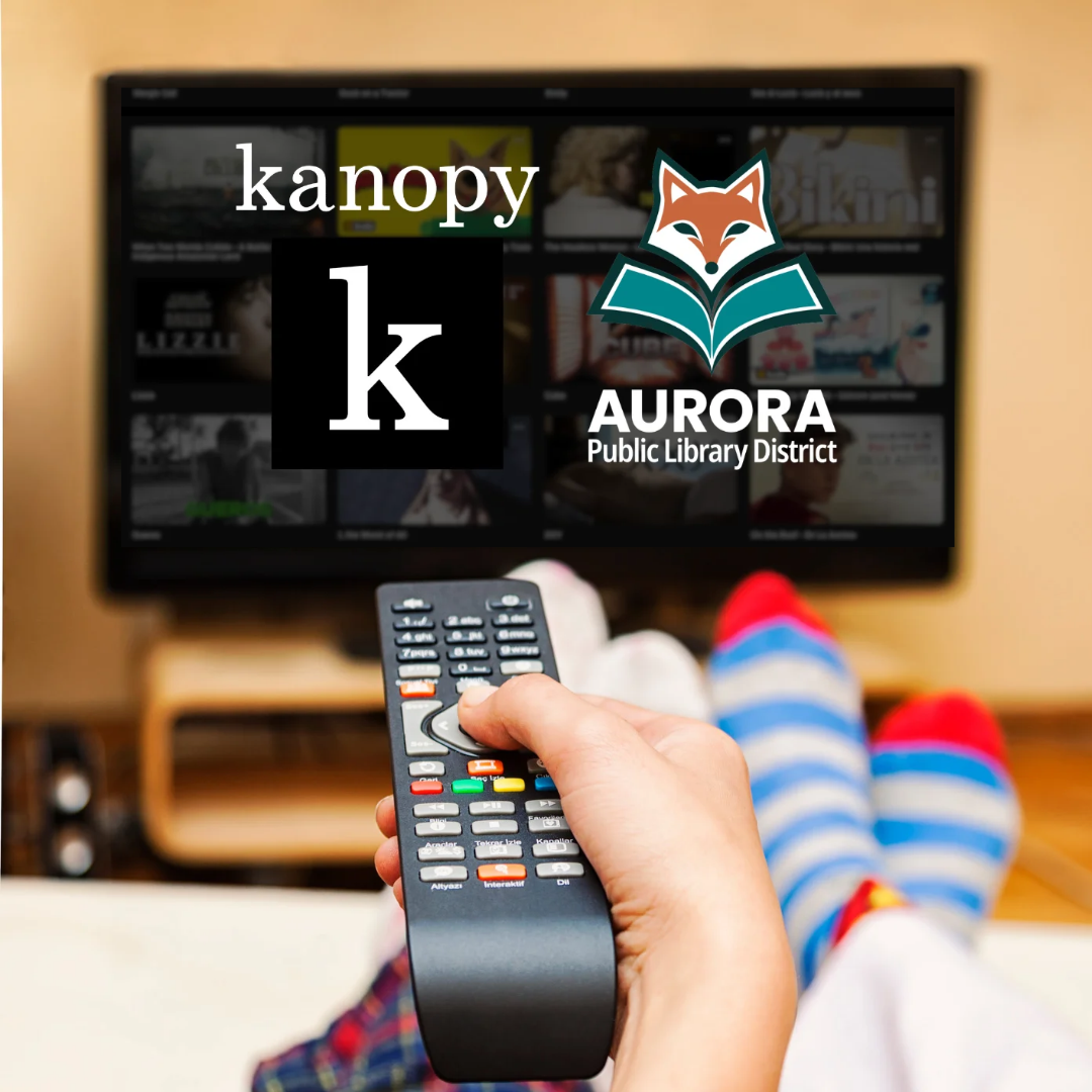Person points a remote at a television screen displaying logos for APLD and Kanopy.